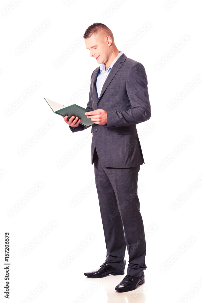 Young businessman reading his note book Young businessman reading his note book
