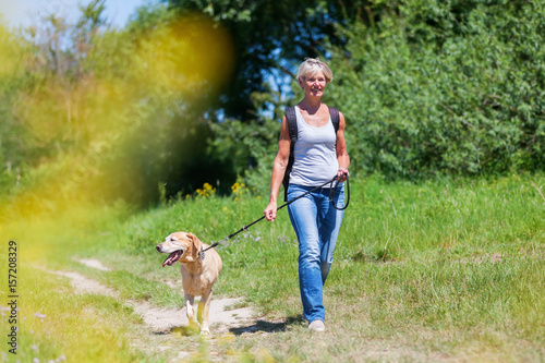mature woman hiking with a dog