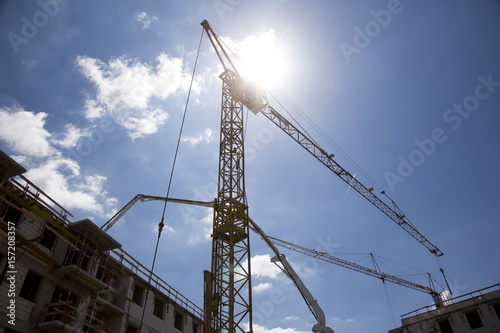 Constrution site with cranes on blue sky backround