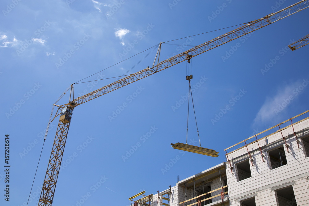 Industrial crane operating and lifting building materials Industrial crane operating and lifting building materials