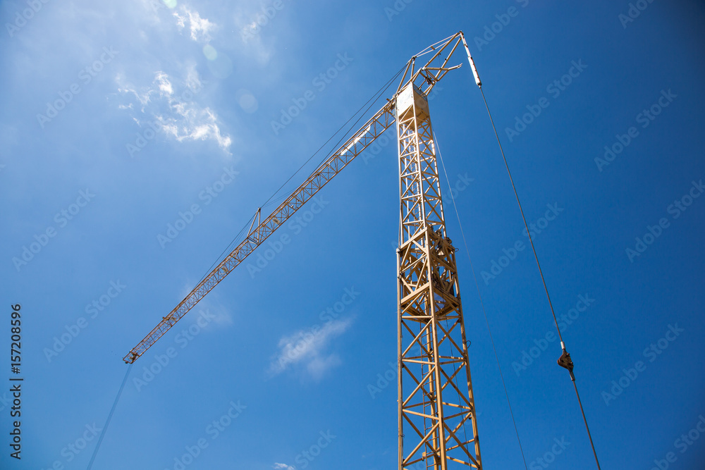 Constrution site with crane on blue sky backround
