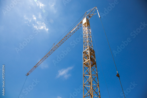 Constrution site with crane on blue sky backround