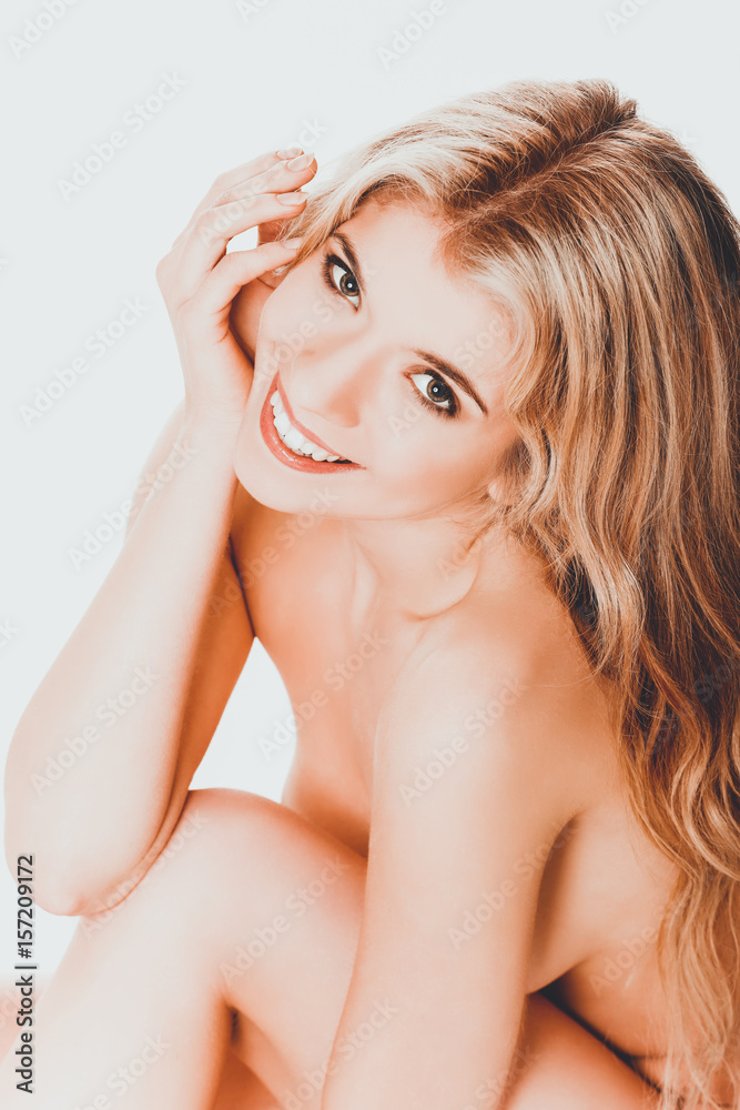 Topless woman with hand under chin Topless woman with hand under chin