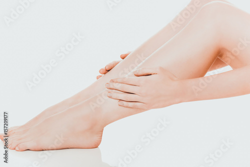 Woman massaging her leg © Piotr Marcinski