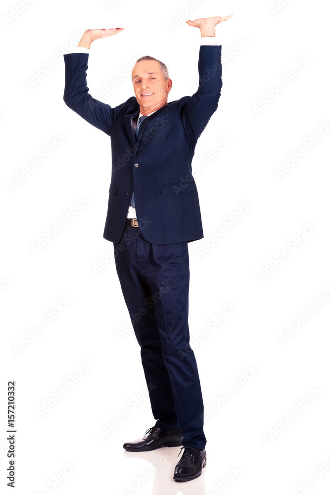 Full length businessman pushing invisible ceiling Full length businessman pushing invisible ceiling