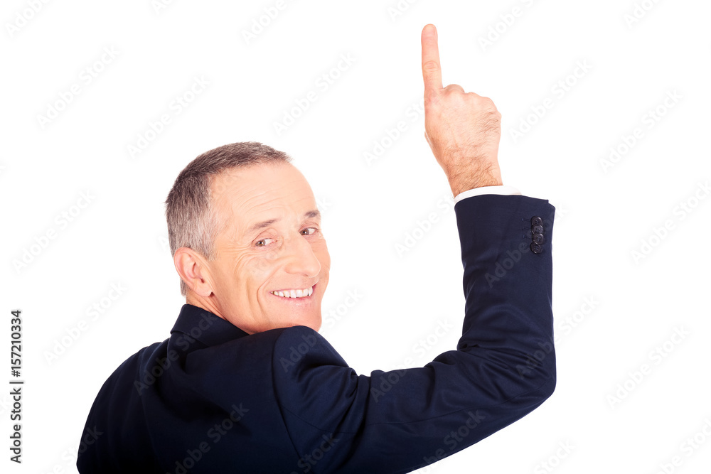 Back view businessman pointing upwards Back view businessman pointing upwards