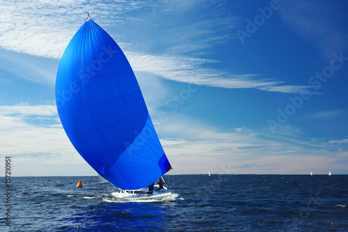 Sailing yacht race. Yachting. Boat with big blue spinnaker sail.