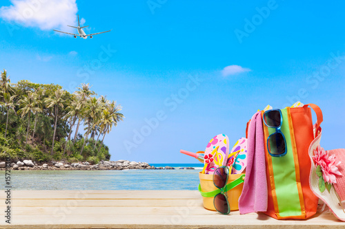Beach accessory,hat,sunglasses,shoes,umbrella on wooden, concept summer holiday background and summer sale.