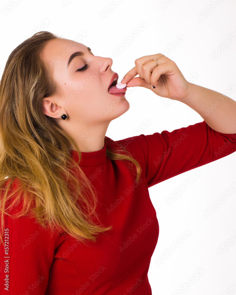 Young pretty woman, pill, white background  