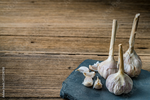 Garlic on black stone plate photo