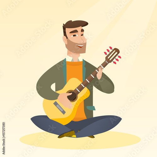 Man playing the acoustic guitar.