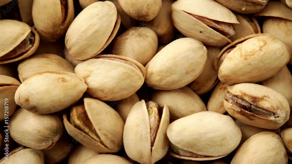 Food background. Roasted pistachio nuts seed with shell close up. Dieting concept. Dolly slider shot 4K ProRes HQ codec Food background. Roasted pistachio nuts seed with shell close up. Dieting concept. Dolly slider shot 4K ProRes HQ codec