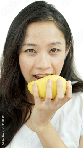 Asian beautiful woman eating mango. Summer delight tropical fruit.