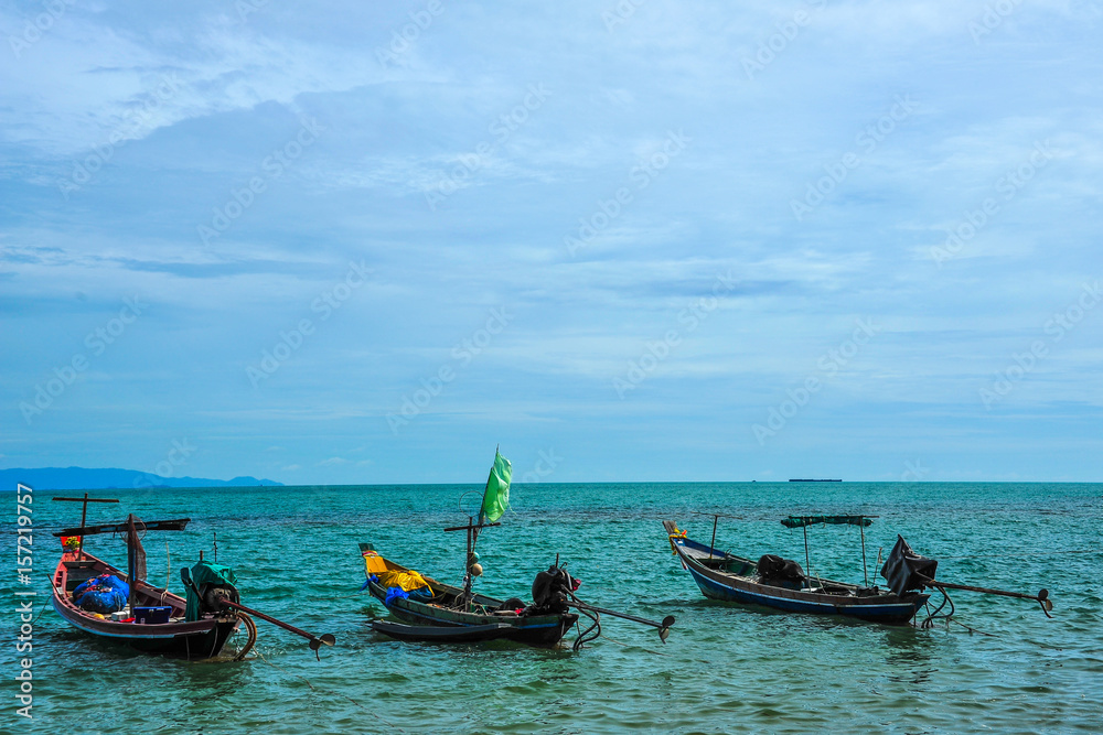 Three fishing boats floating on sea