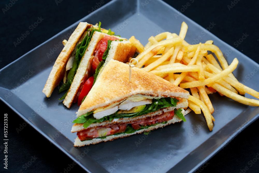 Club sandwiches with french fries on side Club sandwiches with french fries on side