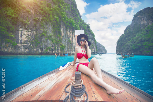 Beautiful girl in red bikini on boat.