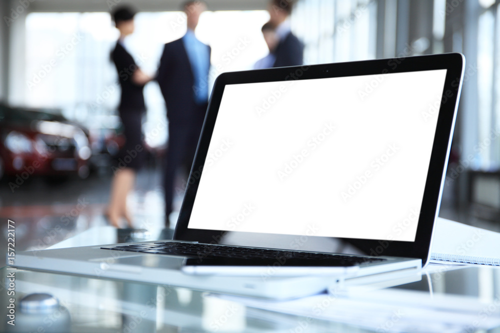 Laptop with blank screen on table. Laptop with blank screen on table.