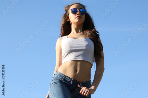 Beautiful Young Woman over blue Sky