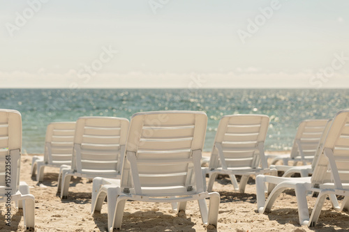 Lots of sun loungers on the beach near the sea. © COLOR PHOTO
