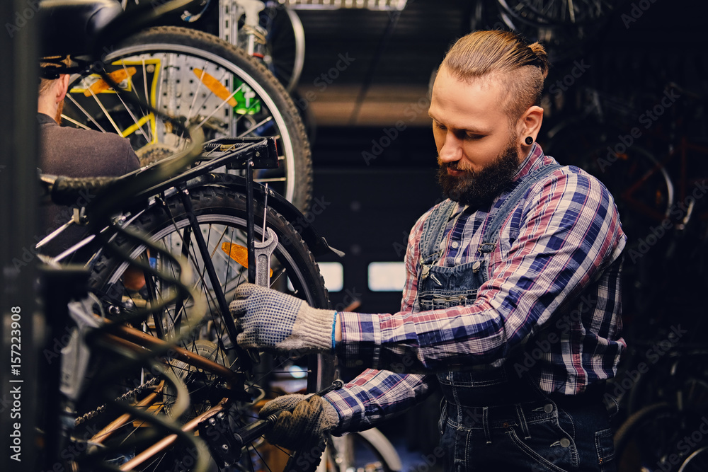 Mechanic fixing rear derailleur from a bicycle. Mechanic fixing rear derailleur from a bicycle.