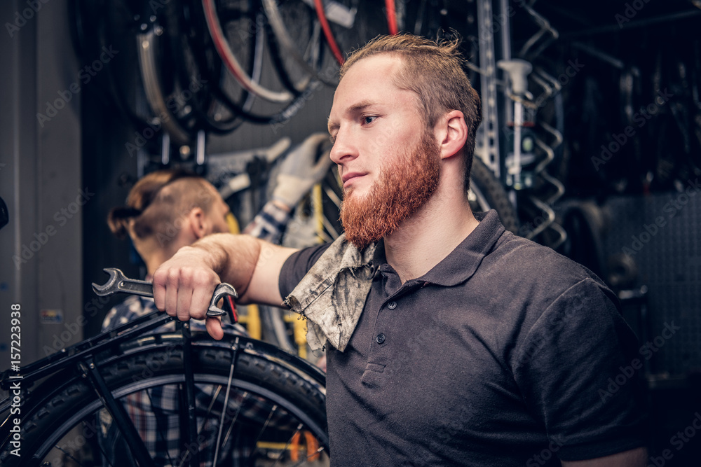 Mechanic fixing rear derailleur from a bicycle. Mechanic fixing rear derailleur from a bicycle.