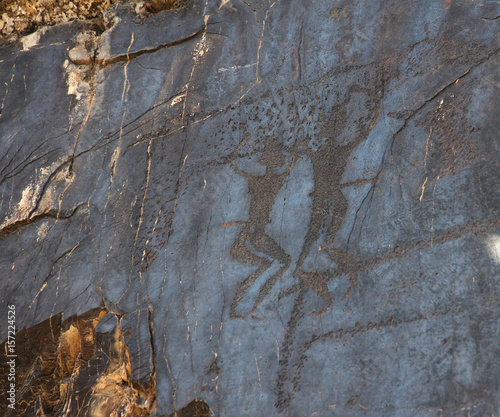 ancient rock drawings (petroglyph), two dancing human
