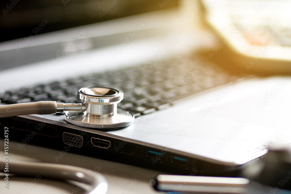 Stethoscope with record information paper and Laptop on desk Doctor in hospital, Healthcare and medical concept Stethoscope with record information paper and Laptop on desk Doctor in hospital, Healthcare and medical concept
