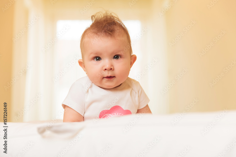 adorable baby girl with serious face looks at the camera adorable baby girl with serious face looks at the camera