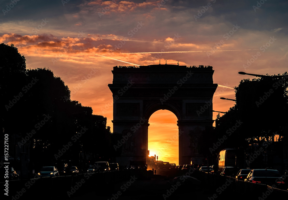 Fototapeta premium Arc de Triomphe in Paris under sunset sky with clouds. One of sy