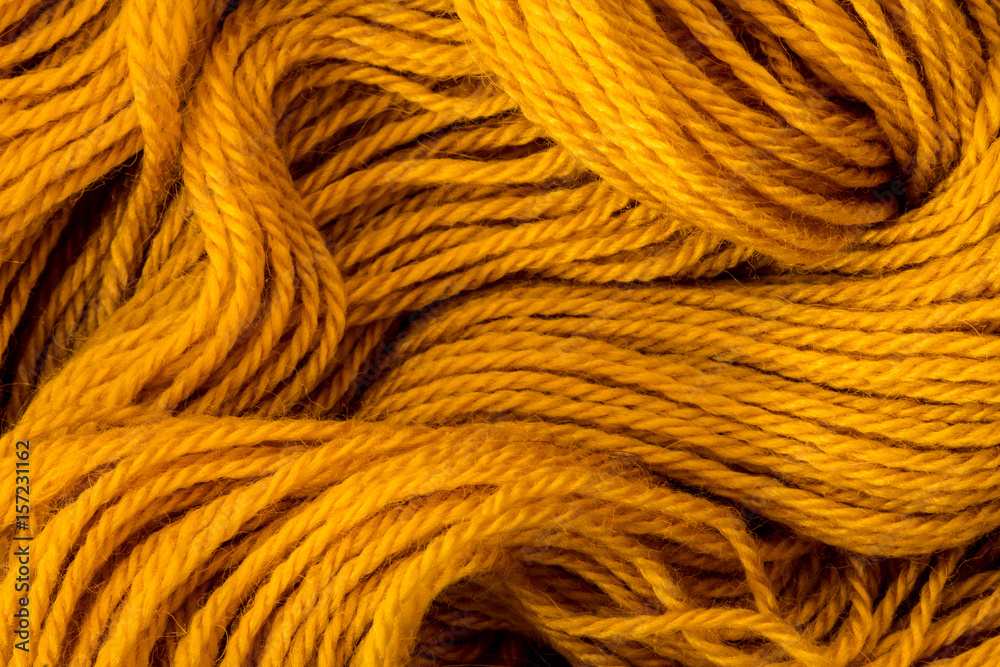 Close up the golden yellow yarn thread as abstract background Close up the golden yellow yarn thread as abstract background