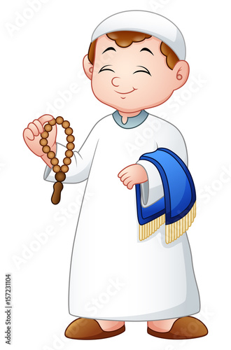 Muslim kid holding praye beads and prayer rug