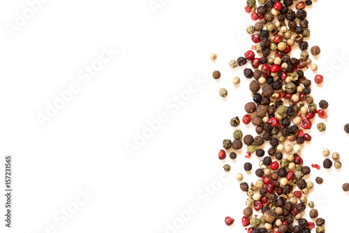 Close up mixed type of peppercorns  on the white background with copy space , top view or overhead shot