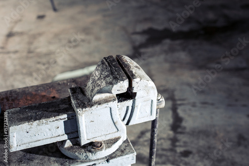 tool mechanics on the table in the garage. Articulating magic friction arm large super clamp crab plier clip. photo