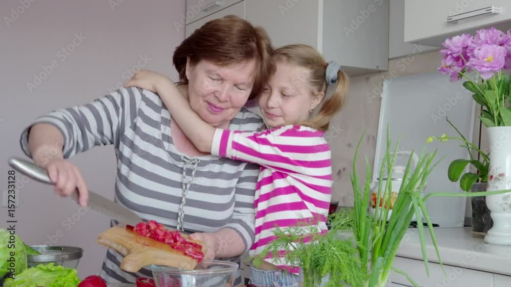 Cooking grandma and granddaughter in the kitchen