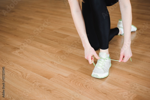 Attractive young fitness model girl working out, doing weight training. Front view. Foot views.