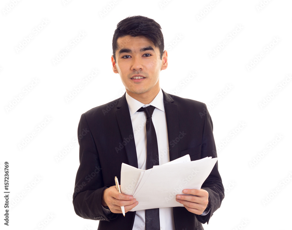 Young man in suit holding papers Young man in suit holding papers
