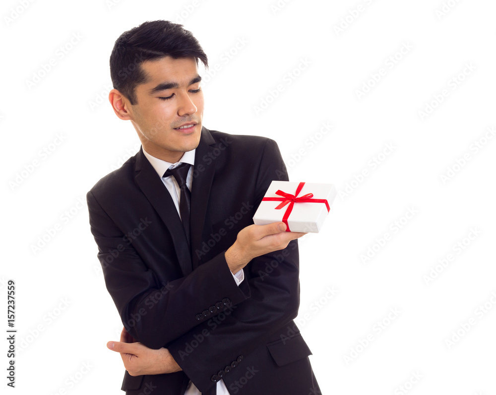 Young man in suit holding a present Young man in suit holding a present
