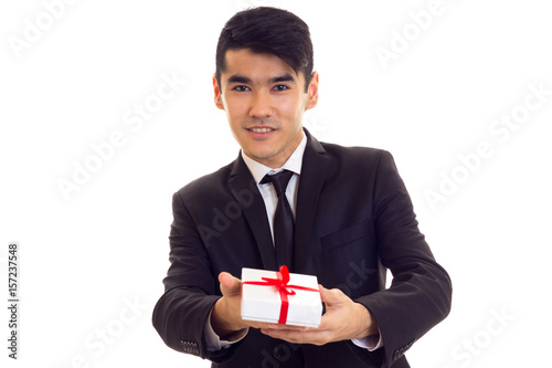 Young man in suit holding a present