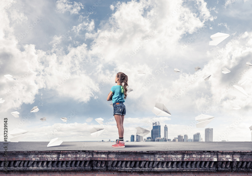Concept of careless happy childhood with girl looking far away Concept of careless happy childhood with girl looking far away