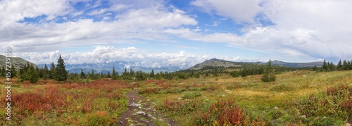 The nature of the Southern Urals. After the rain. Summer in the mountains. Panorama of a beautiful sky with clouds against the backdrop of mountains and forests.