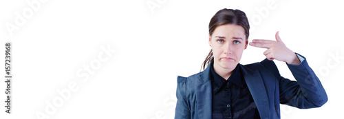 Young business woman with hand to head in the shape of gunisolated on white. photo