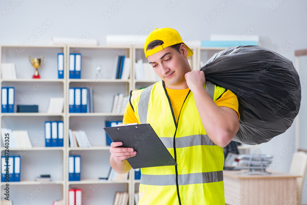 Man cleaning the office and holding garbage bag Man cleaning the office and holding garbage bag