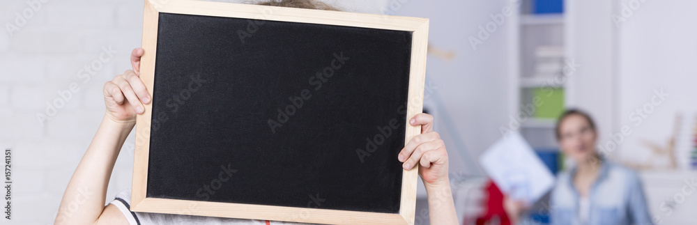 Child holding a blackboard Child holding a blackboard