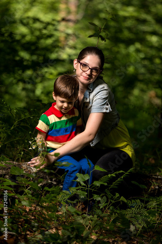 mother and son playing in the forest © dinostock
