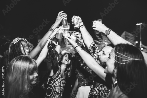 Group of Friends Drinking Beers Enjoying Music Festival Together photo