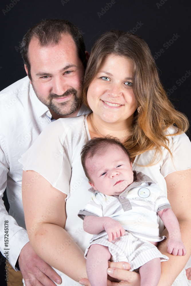 A family of 3 with a newborn baby
