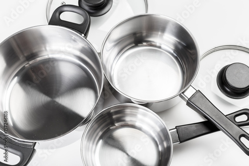 Stainless steel pots and pans isolated on white