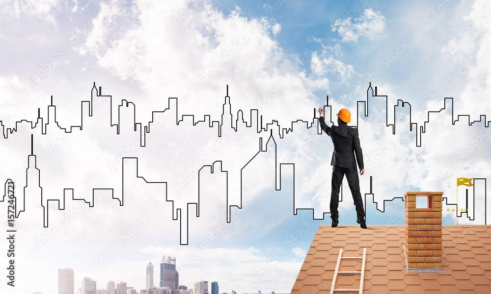 Man architect draw silhouette of modern city on blue sky. Mixed media Man architect draw silhouette of modern city on blue sky. Mixed media