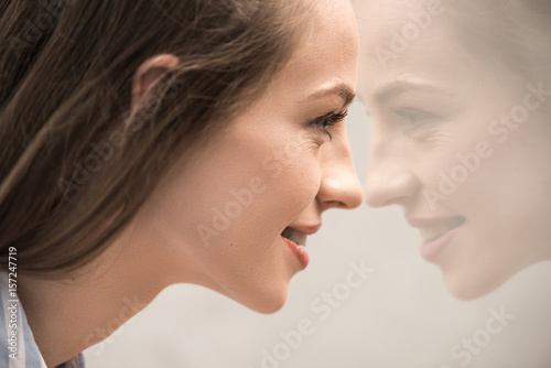 close up of young attractive caucasian girl looking at her reflection