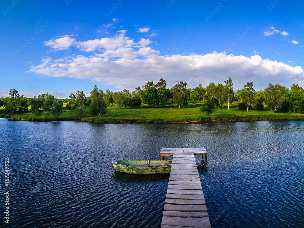 Background of nature landscape with clouds and lake with boat
